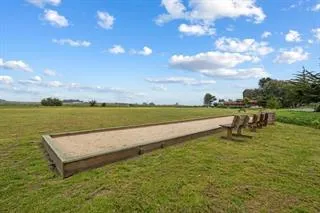 a view of a lake with couches in the back