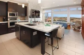 a kitchen with stainless steel appliances kitchen island granite countertop a sink and cabinets