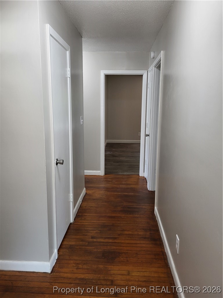 182 Summerhill Road Fayetteville, NC 28303 - Photo 15 of 24 a view of a hallway with wooden floor and staircase
