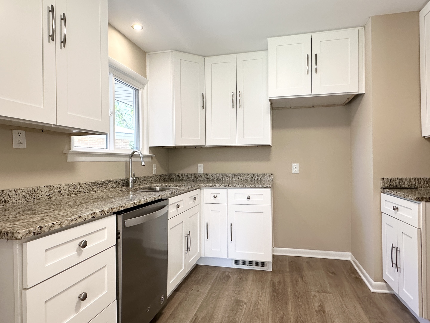 460 South Wall Street Kankakee, IL 60901 - Photo 12 of 52 a kitchen with granite countertop white cabinets and white appliances