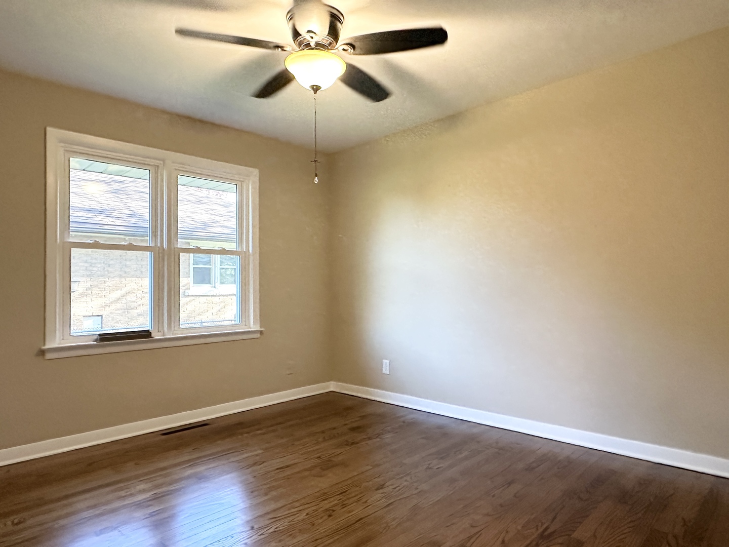 460 South Wall Street Kankakee, IL 60901 - Photo 20 of 52 an empty room with wooden floor fan and windows
