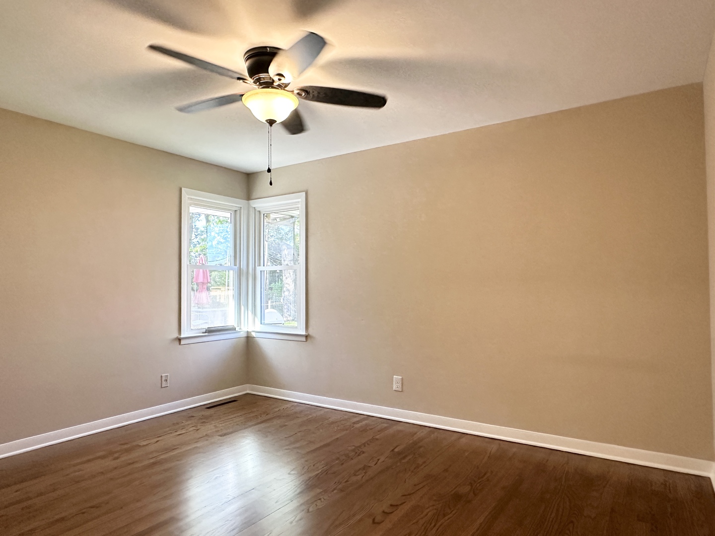 460 South Wall Street Kankakee, IL 60901 - Photo 21 of 52 an empty room with wooden floor chandelier fan and windows