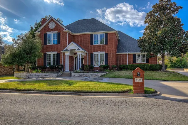 a front view of a house with a yard table and chairs