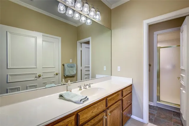 a bedroom with a bed chandelier and a window