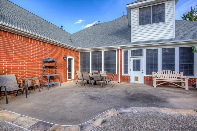 a backyard of a house with table and chairs