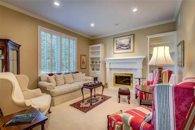 a living room with furniture fireplace and a large window