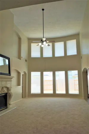 a living room with a fireplace furniture and a ceiling fan