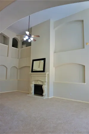 a view of empty room with a fireplace