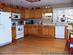 402 Terrys Gap Road Fletcher, NC 28732 - Photo 3 of 9 a kitchen with stainless steel appliances granite countertop a stove a sink and a refrigerator