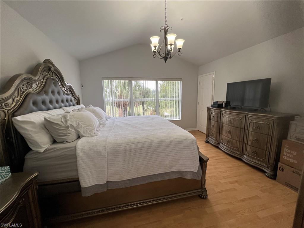 884 Hampton Circle, Unit 159 Naples, FL 34105 - Photo 11 of 28 a bedroom with a bed and a flat tv screen on a dresser