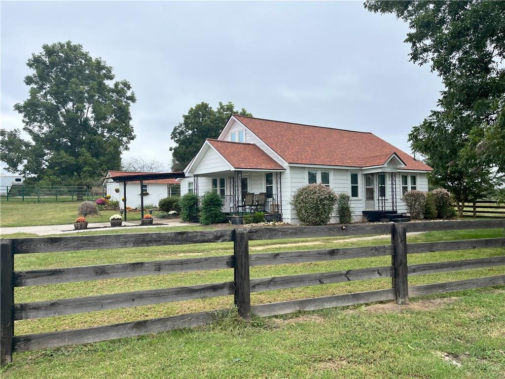 a front view of a house with a yard table and chairs