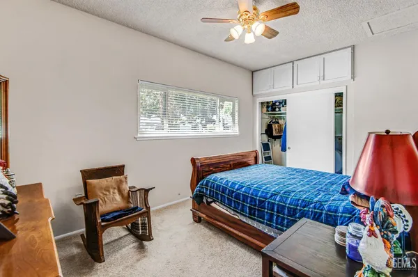 a spacious bedroom with a bed and furniture