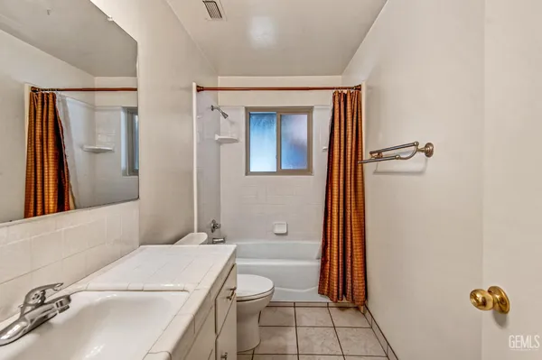 a view of a hallway with paintings on the wall