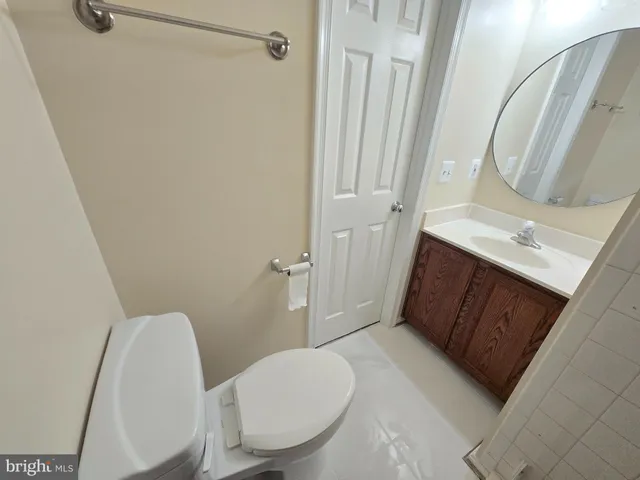 a bathroom with a sink a toilet a mirror and shower