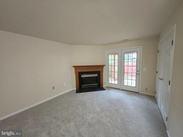 a view of empty room with a fireplace