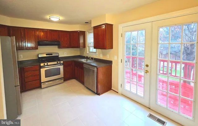 a kitchen with stainless steel appliances granite countertop a stove and a refrigerator