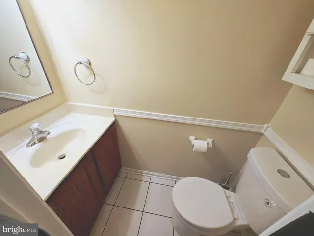 a bathroom with a sink mirror vanity and toilet