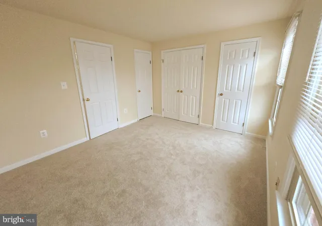 a view of an empty room and a window