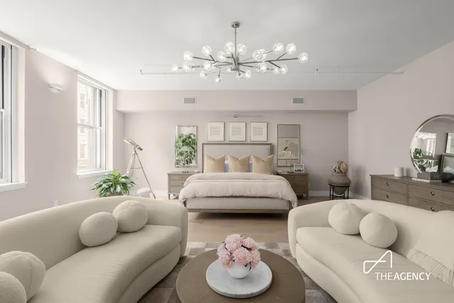 a living room with furniture and a chandelier