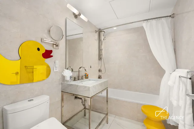 a spacious bedroom with a bed and a flat screen tv