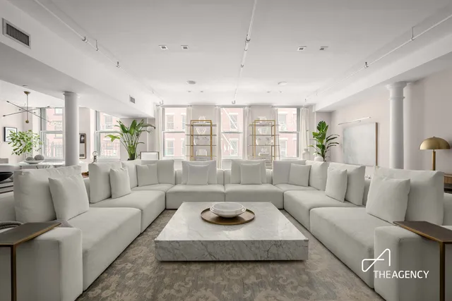 a living room with fireplace furniture and a large window