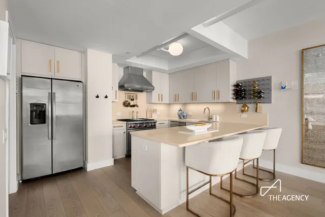 a living room filled with furniture potted plant and a window