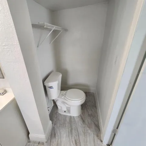 a white toilet sitting next to a white sink