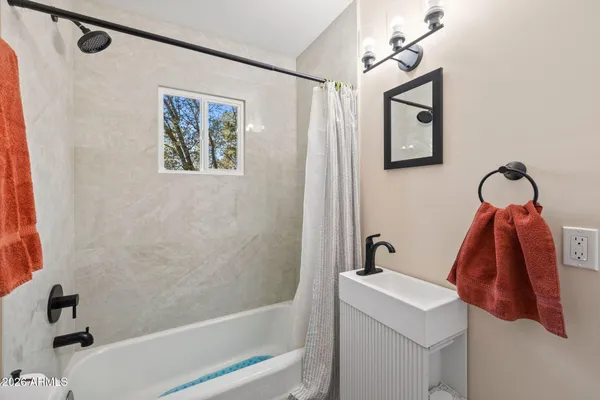 a bathroom with a bathtub and shower