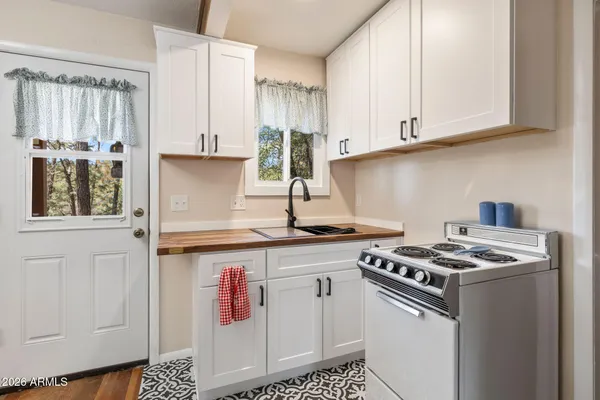 a kitchen with stainless steel appliances a refrigerator and a stove top oven