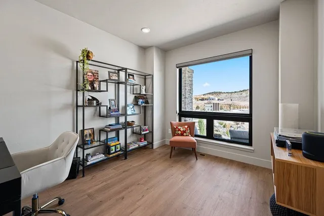 a living room with furniture and a book shelf