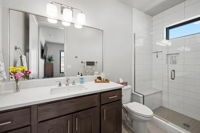 a bathroom with a sink toilet and shower