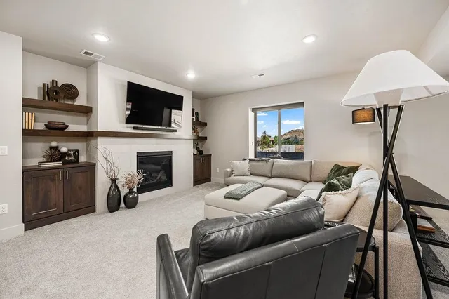 a living room with furniture a fireplace and a flat screen tv
