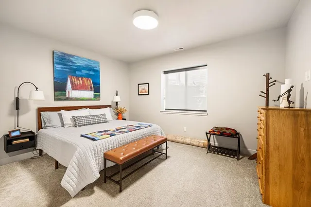 a bedroom with bed and a window