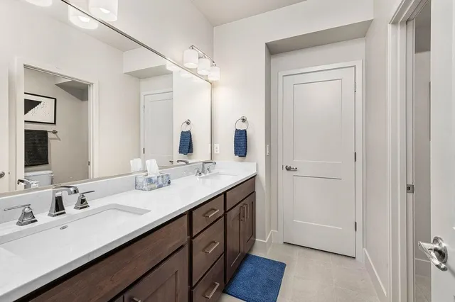 a bathroom with a double vanity sink and a mirror