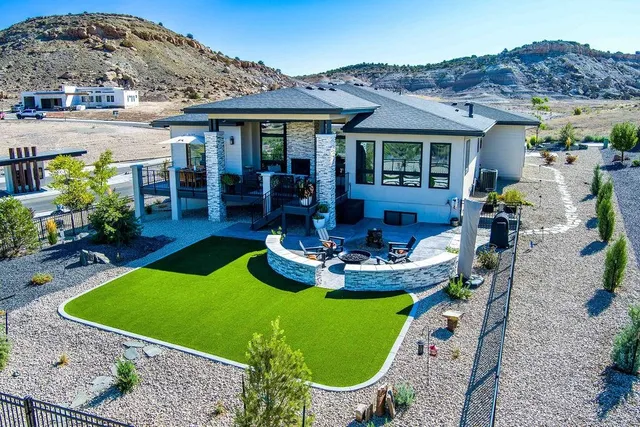 a view of a house with backyard swimming pool and sitting area