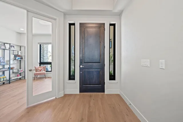 a view of a big room with wooden floor and a bathroom