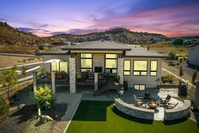 a view of a patio with couches table and chairs and a potted lots of water view