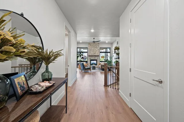 a hallway with dining room and wooden floor
