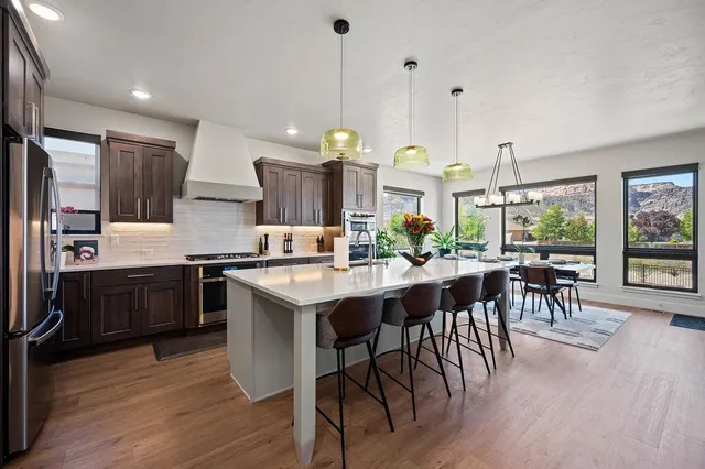 a kitchen with a table chairs sink and cabinets
