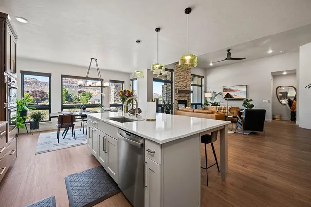 a kitchen with stainless steel appliances granite countertop a stove and a wooden floors