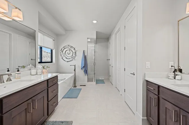 a spacious bathroom with a double vanity sink and a mirror
