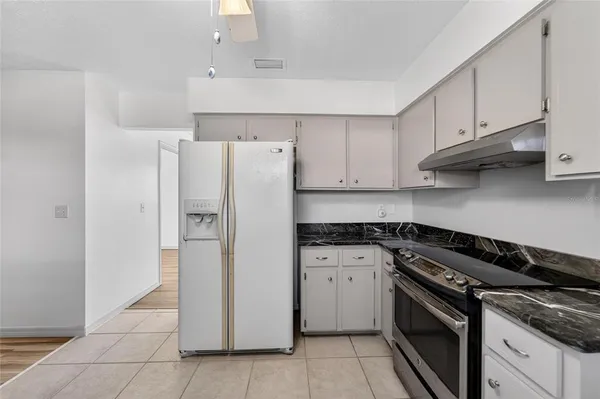a view of an empty room with a fireplace and a window