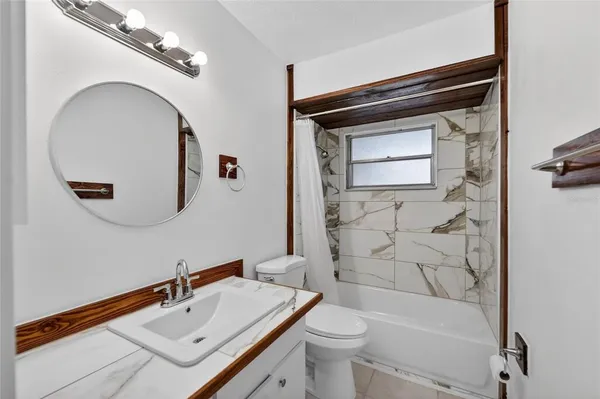 a view of an empty room with a window and entryway