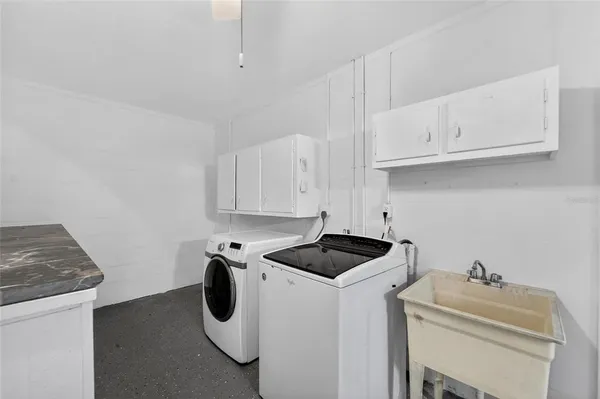 a front view of house with yard and trees in the background