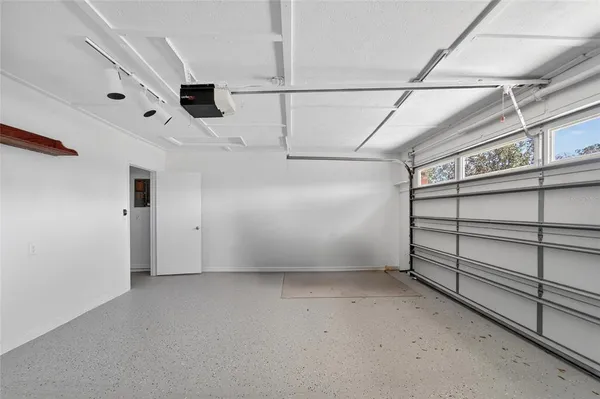 a view of a backyard with table and chairs potted plants and wooden fence