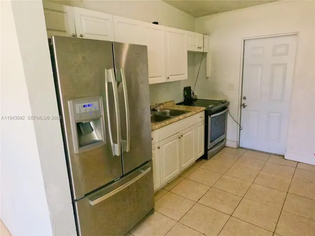 a kitchen with stainless steel appliances a refrigerator sink and stove