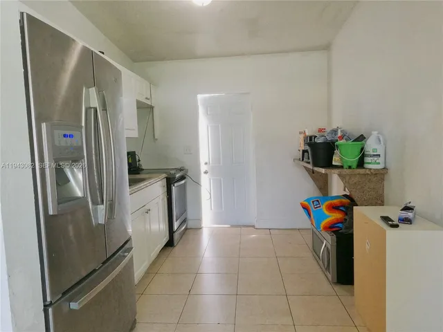 a kitchen with stainless steel appliances granite countertop a refrigerator and a counter space