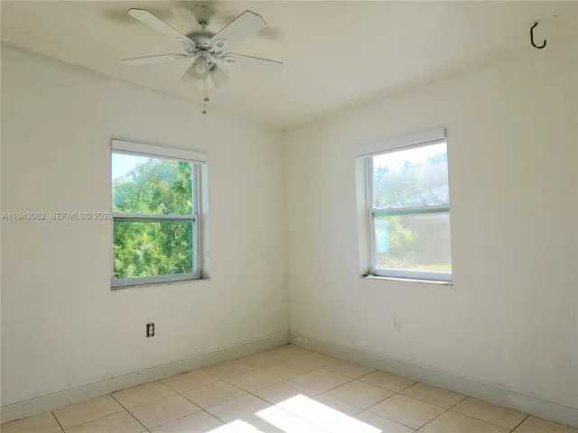 an empty room with windows and closet