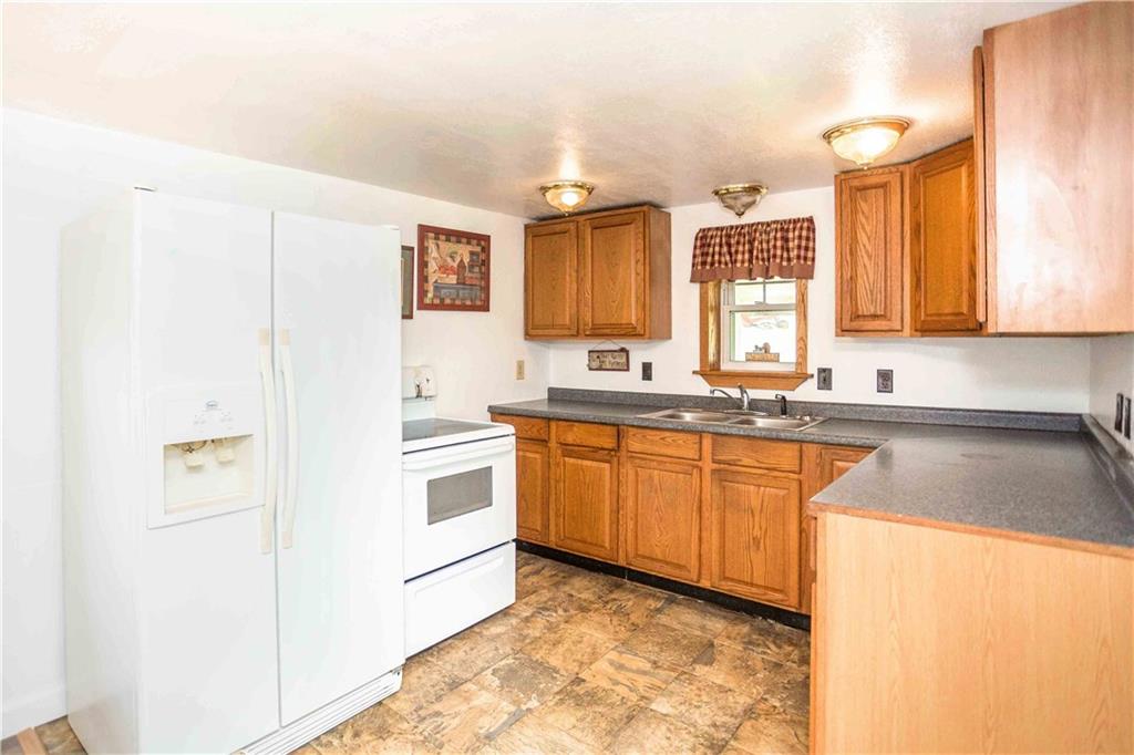 7336 Pollock Road Marion Center, PA 15759 - Photo 8 of 28 a kitchen with granite countertop a sink cabinets stainless steel appliances and a window
