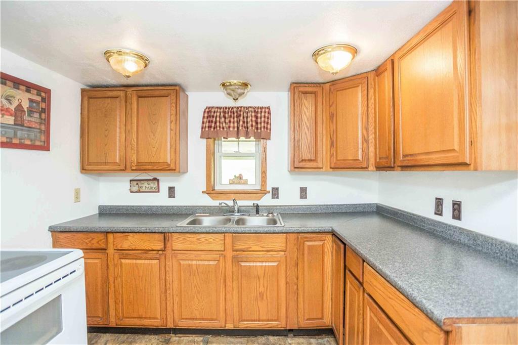 7336 Pollock Road Marion Center, PA 15759 - Photo 9 of 28 a kitchen with granite countertop cabinets sink and window